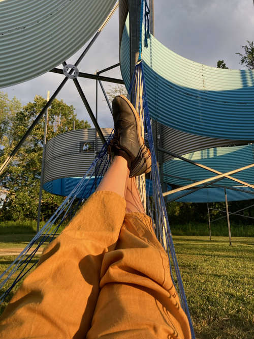 point of view shot of legs and feet in a hammock